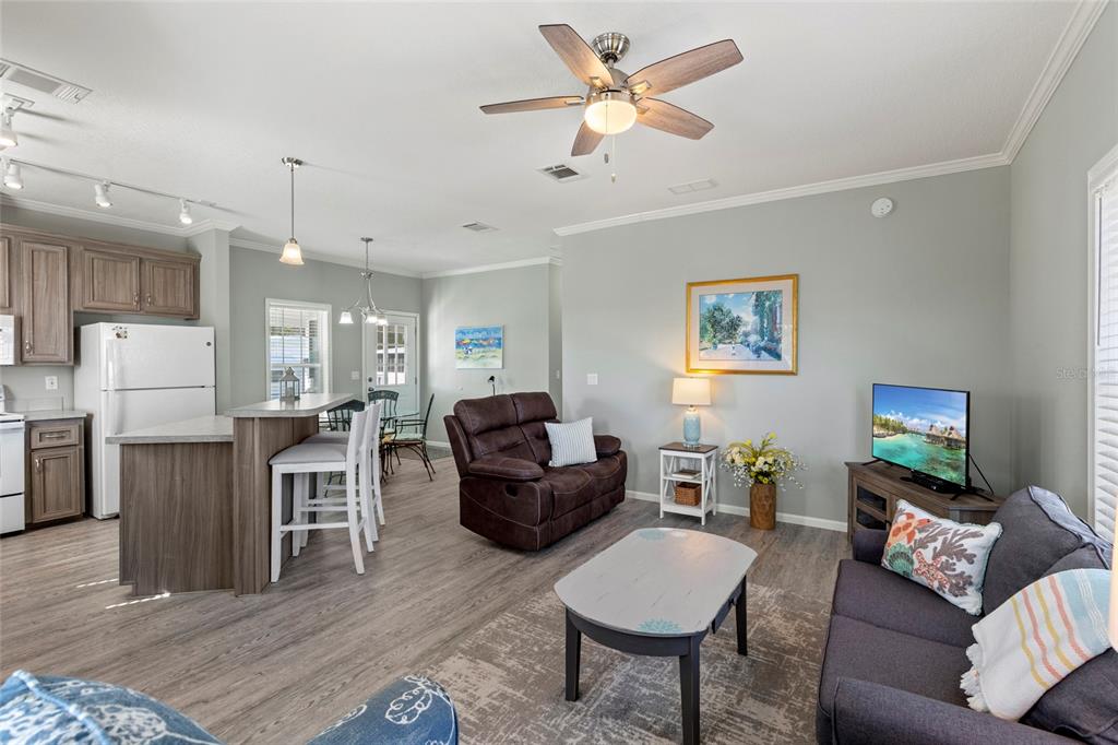 4104 11th Street East Ellenton, FL 34222 - Photo 4 of 20 a living room with furniture a ceiling fan a rug and a window