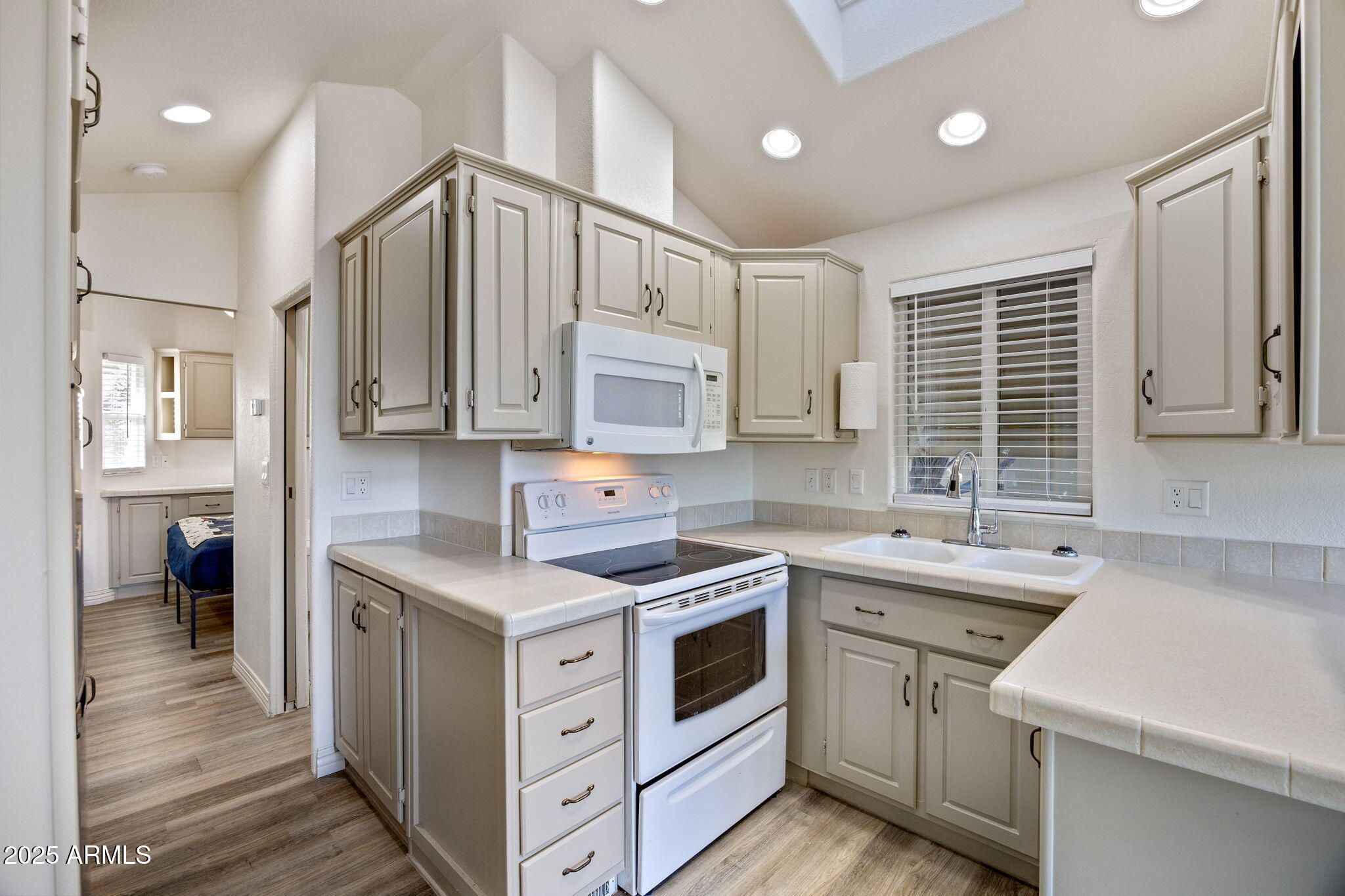 2209 Old Crooks Trail Overgaard, AZ 85933 - Photo 10 of 38 a kitchen with stainless steel appliances cabinets a sink and a window