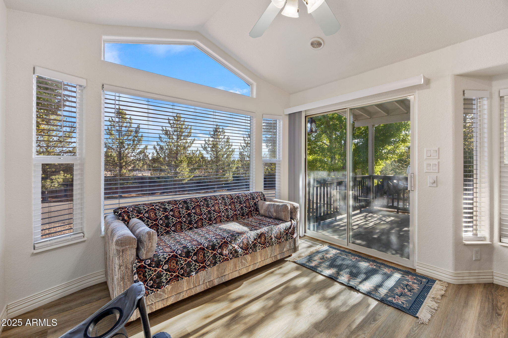 2209 Old Crooks Trail Overgaard, AZ 85933 - Photo 8 of 38 a bed sitting in a bedroom next to a window