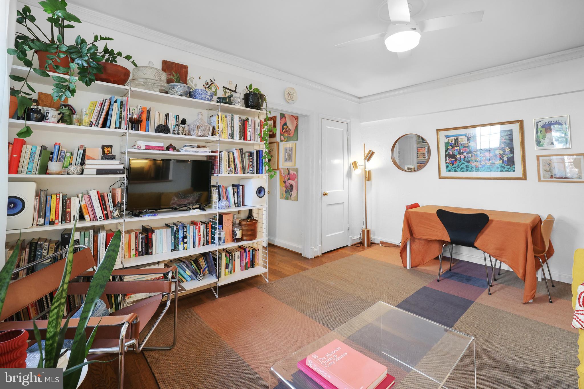 1441 Euclid Street Northwest, Unit 206 Washington, DC 20009 - Photo 4 of 19 a living room with lots of books and a large window