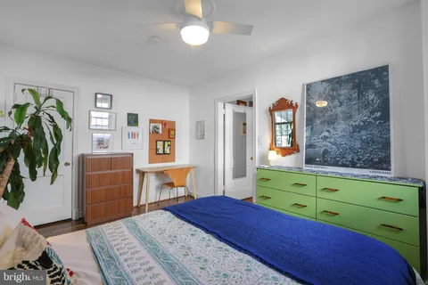 a bedroom with a bed and a dresser in it