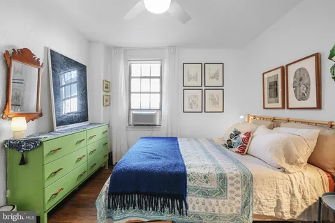 a bed room with a bed and a mirror