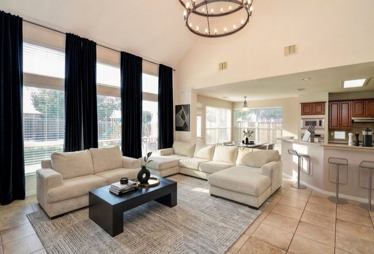 19802 Shavon Springs Drive Spring, TX 77388 - Photo 10 of 30 Virtullay staged living room setup idea high ceilings and an elegant chandelier—perfect for relaxation and entertaining