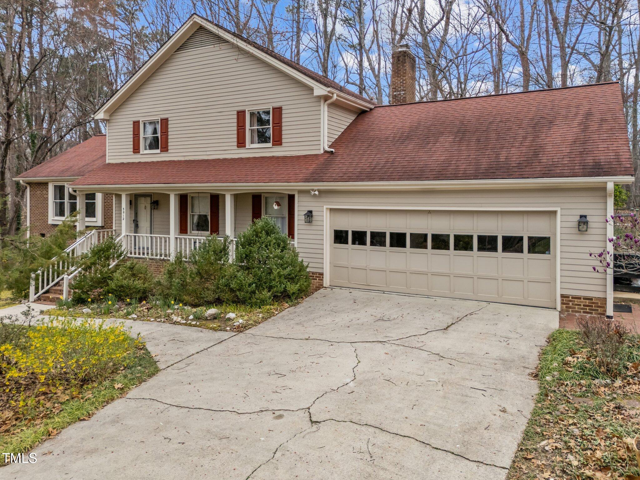 5012 Springwood Drive Raleigh, NC 27613 - Photo 1 of 44 a view of a white house with a large trees