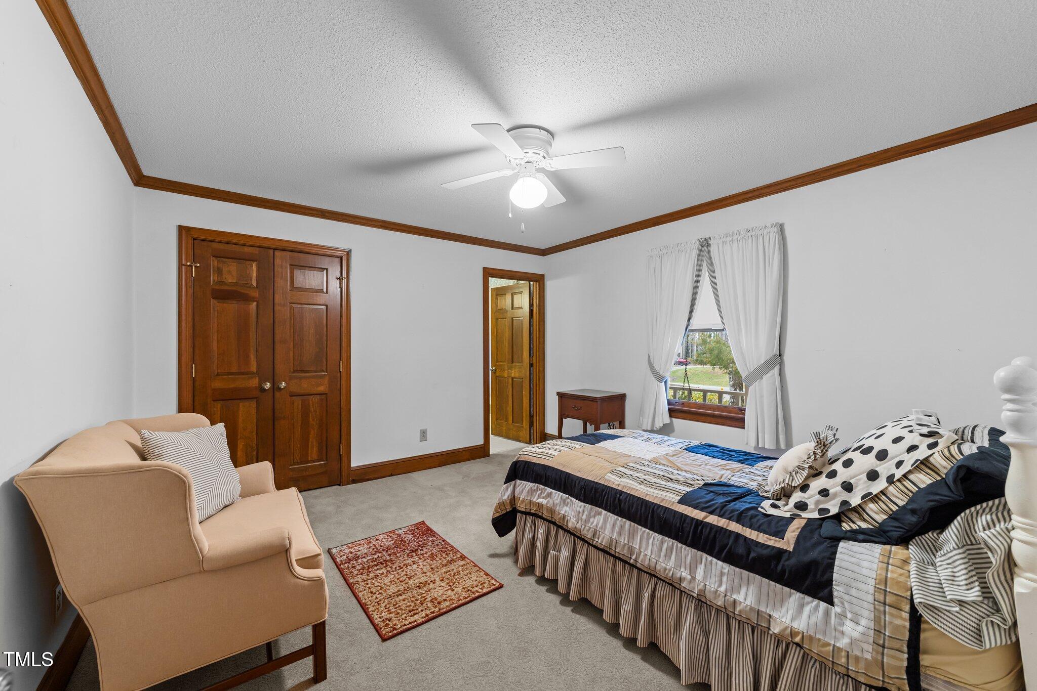5012 Springwood Drive Raleigh, NC 27613 - Photo 20 of 44 a bedroom with furniture and a window