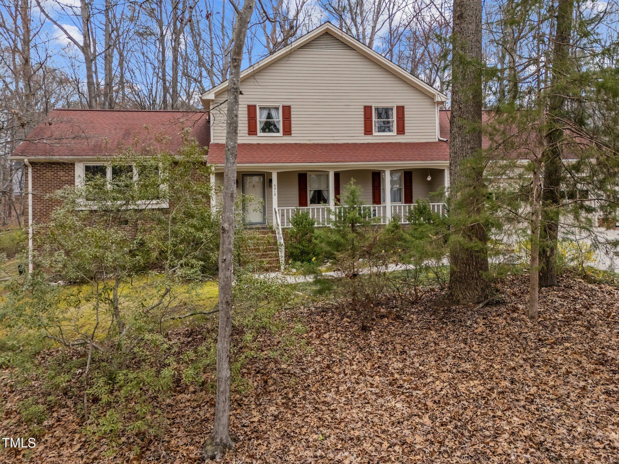 5012 Springwood Drive Raleigh, NC 27613 - Photo 2 of 44 a front view of a house with a yard