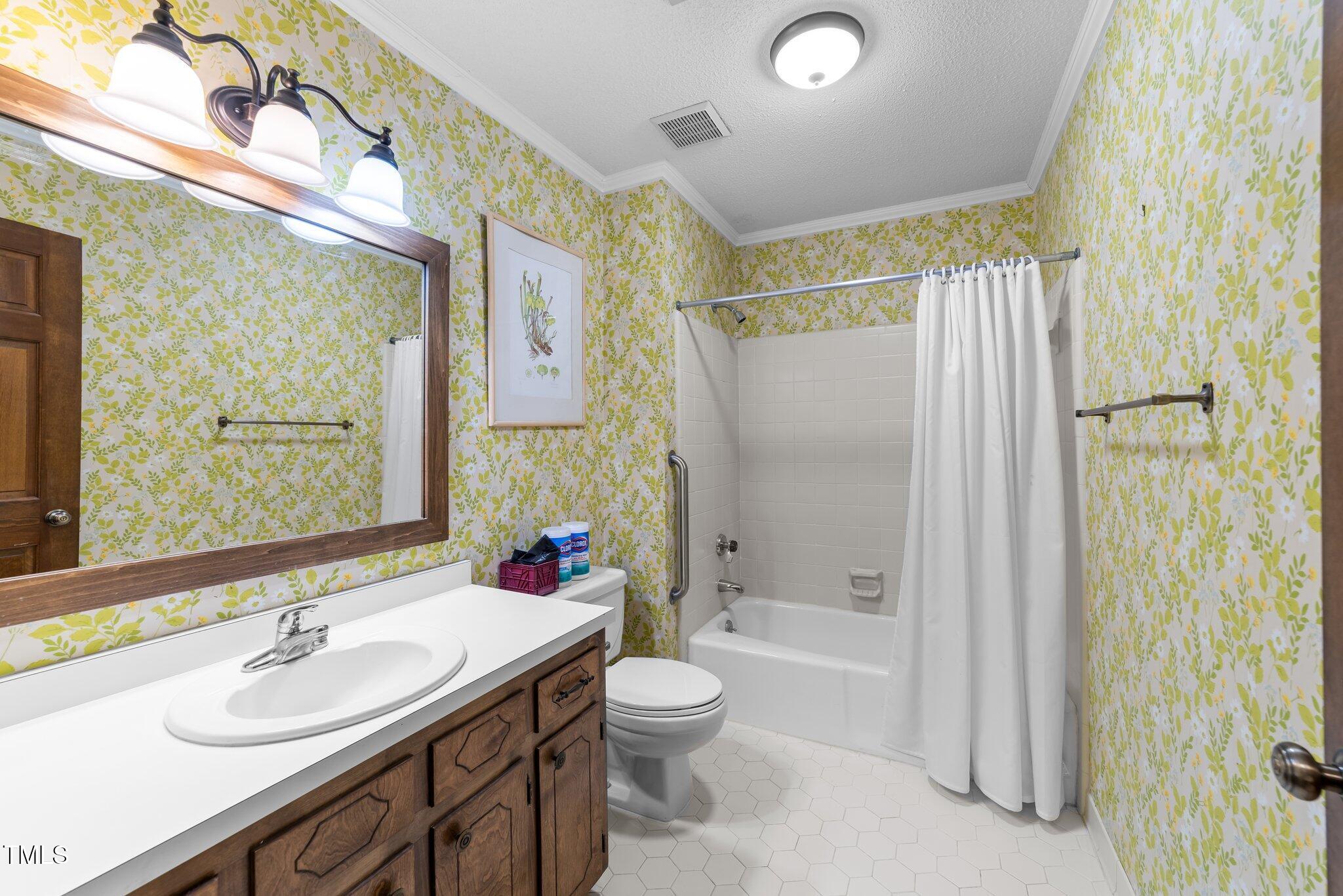 5012 Springwood Drive Raleigh, NC 27613 - Photo 31 of 44 a bathroom with a double vanity sink toilet mirror and shower