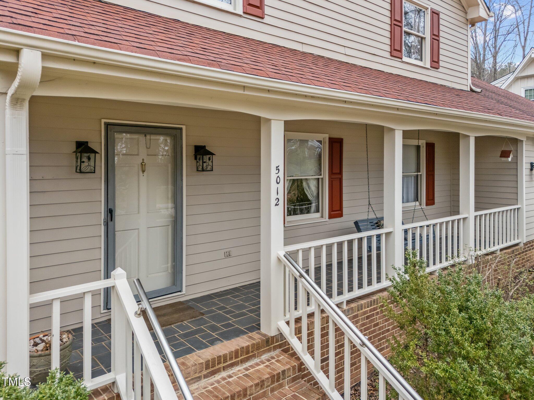 5012 Springwood Drive Raleigh, NC 27613 - Photo 4 of 44 front view of a house with a porch