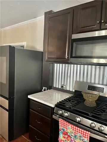 a stove top oven sitting inside of a kitchen