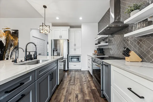 a kitchen with a sink stainless steel appliances and cabinets