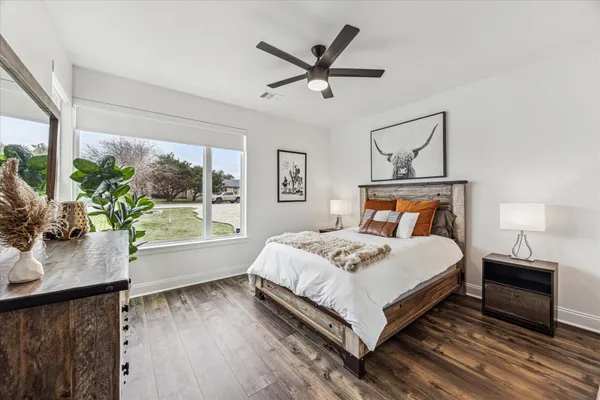 a bedroom with a large bed and a large window