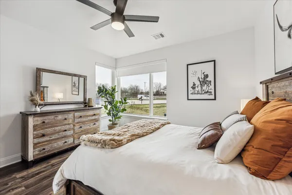a bedroom with a bed and wooden floor