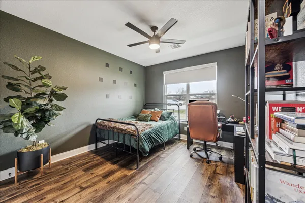 a bedroom with furniture window and wooden floor