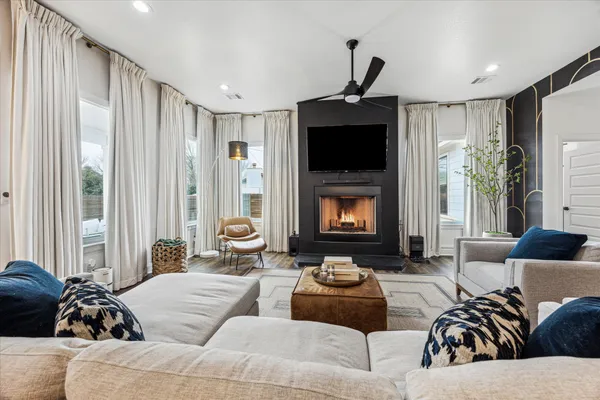a living room with furniture fireplace and a flat screen tv