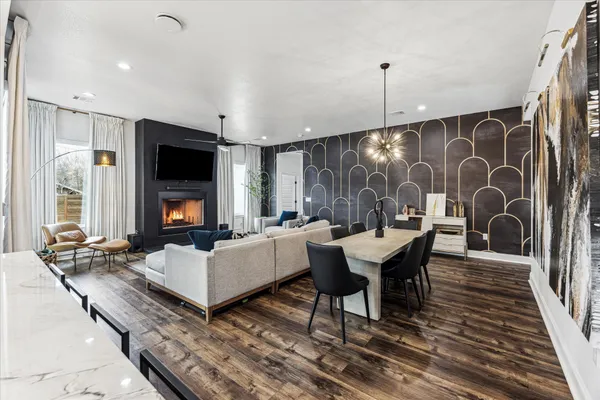 a living room with furniture a rug and a flat screen tv
