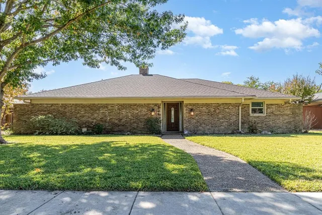 a view of a swimming pool with lawn chairs under an umbrella