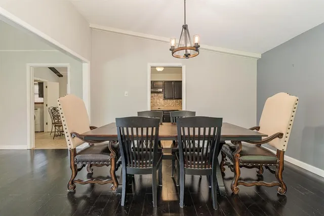 a view of a dining room with furniture wooden floor and chandelier