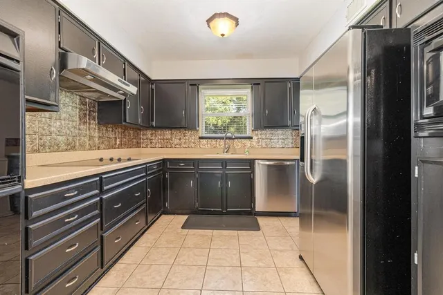 a kitchen with a sink stove and refrigerator