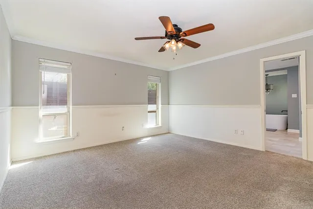 a view of a livingroom with a ceiling fan and window