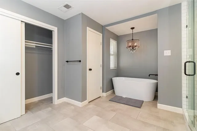 a bathroom with a bathtub and shower