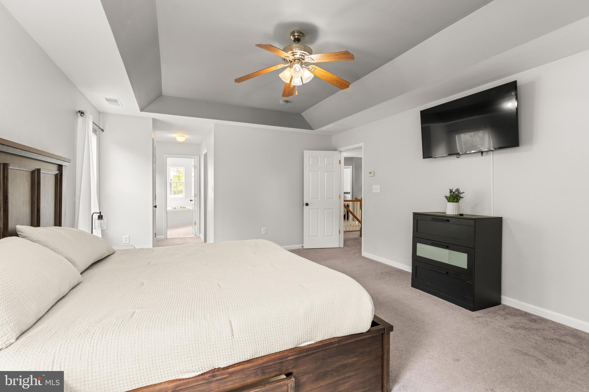 8289 WB&A Road Severn, MD 21144 - Photo 7 of 45 a spacious bedroom with a bed and a flat screen tv