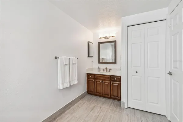 a bedroom with a bed and a painting on the wall