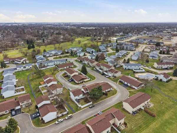 an aerial view of residential houses with outdoor space