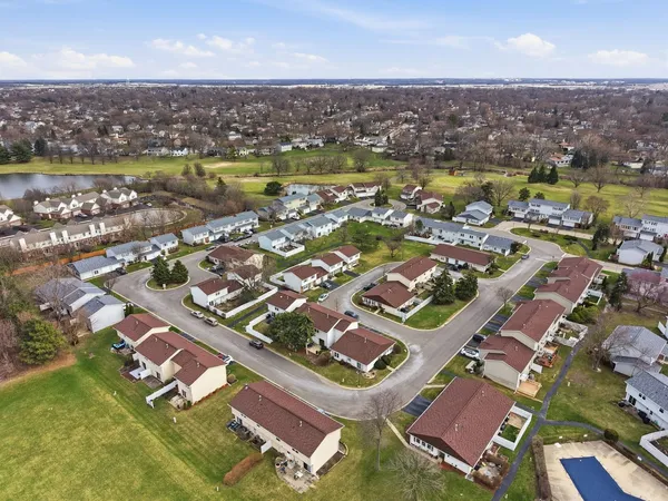 an aerial view of residential houses with outdoor space