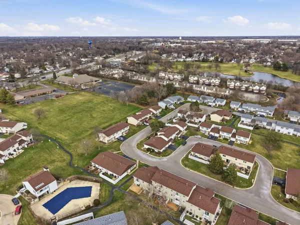an aerial view of residential houses with city view