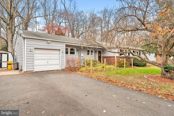 a view of a house with a yard and garage