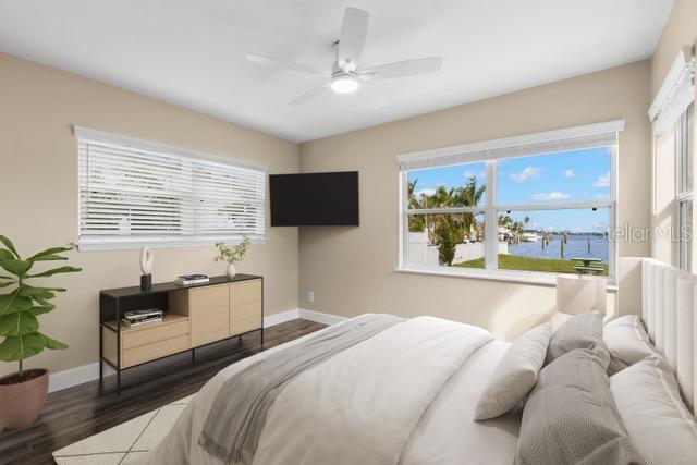 708 Sunset Cove Madeira Beach, FL 33708 - Photo 23 of 61 a bedroom with a bed and a flat screen tv