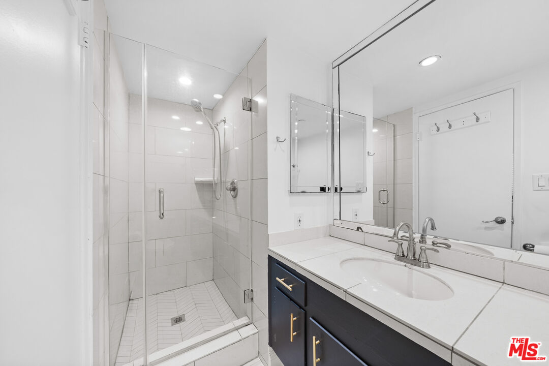 148 South Reeves Drive, Unit 4 Beverly Hills, CA 90212 - Photo 21 of 27 a bathroom with a shower sink and mirror
