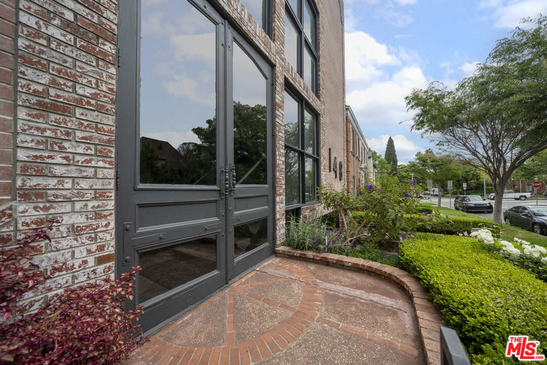 148 South Reeves Drive, Unit 4 Beverly Hills, CA 90212 - Photo 4 of 27 a view of a entrance gate of the house and trees