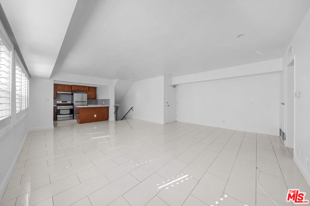 148 South Reeves Drive, Unit 4 Beverly Hills, CA 90212 - Photo 9 of 27 an empty room with windows