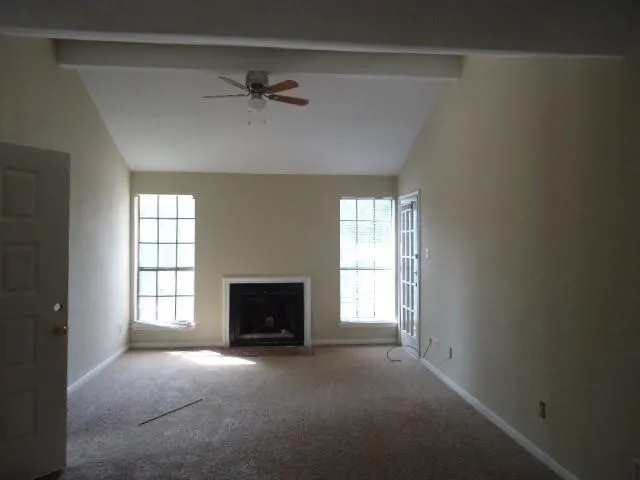 a view of empty room with a fireplace