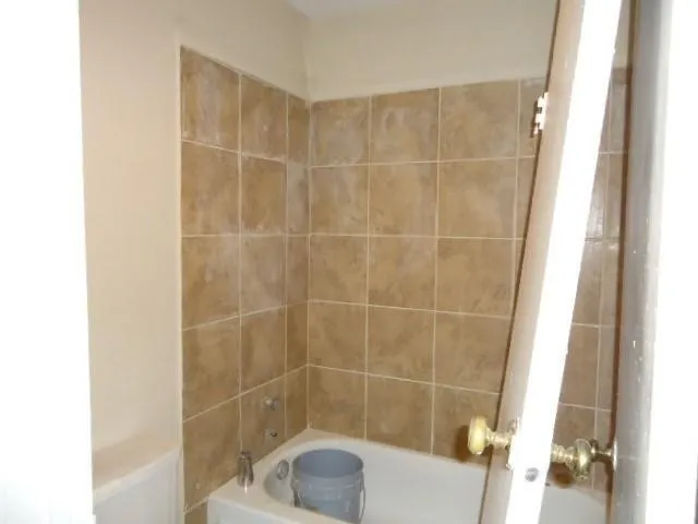 a bathroom with a shower and a sink
