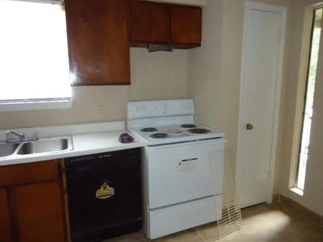 a utility room with sink dryer and washer