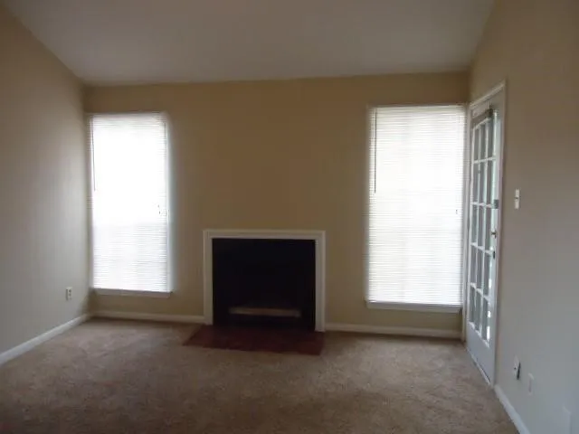 an empty room with a fireplace