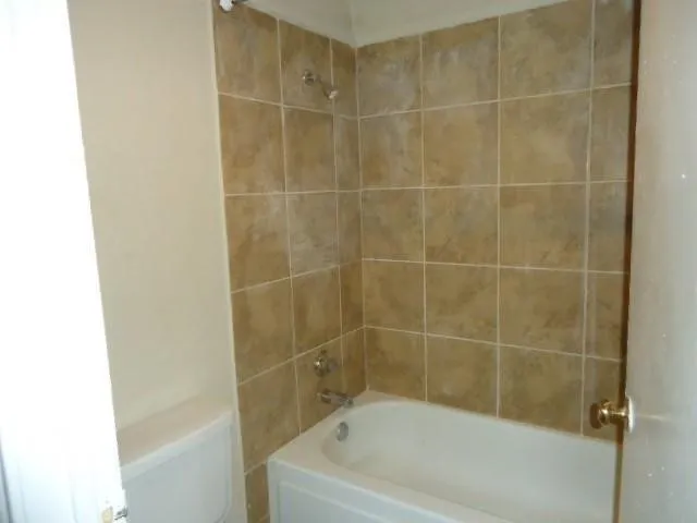 a bath tub sitting next to a white sink