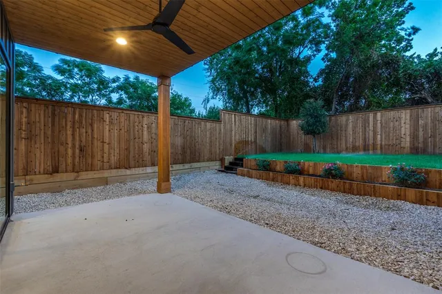 a view of backyard with wooden fence
