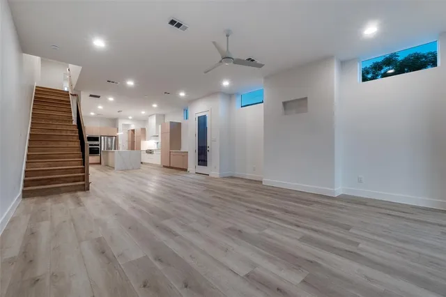 a view of a hallway with stairs and a couch