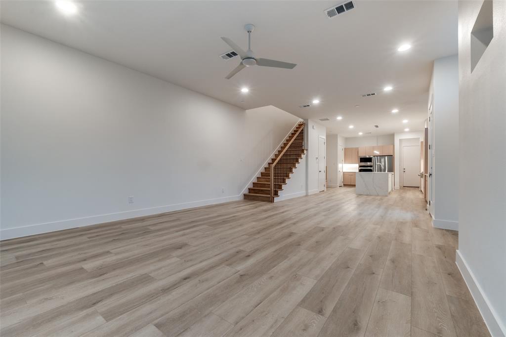 4515 Afton Street Dallas, TX 75219 - Photo 15 of 25 a view of a hallway with wooden floor and a ceiling fan