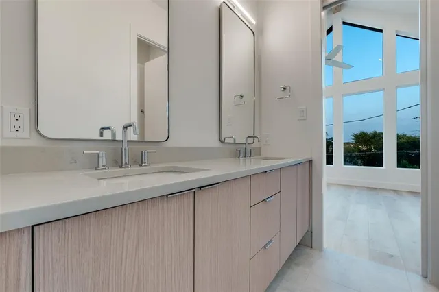 a bathroom with a double vanity sink and a mirror