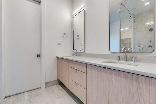 a bathroom with a double vanity sink and a mirror