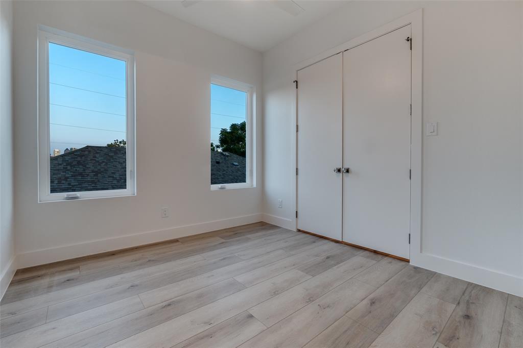 4515 Afton Street Dallas, TX 75219 - Photo 20 of 25 a view of an empty room with wooden floor and a window