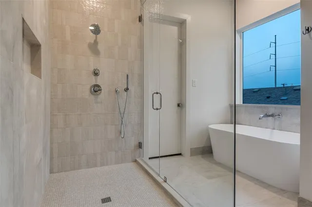 a bathroom with a bathtub and shower