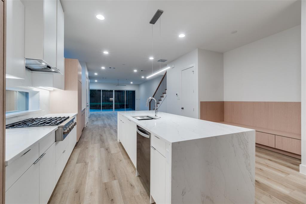 4515 Afton Street Dallas, TX 75219 - Photo 10 of 25 a large kitchen with stainless steel appliances a large counter top a stove and a refrigerator