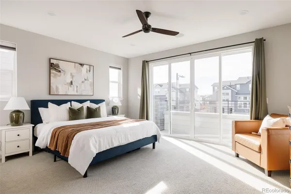 a bedroom with a large bed and a large window
