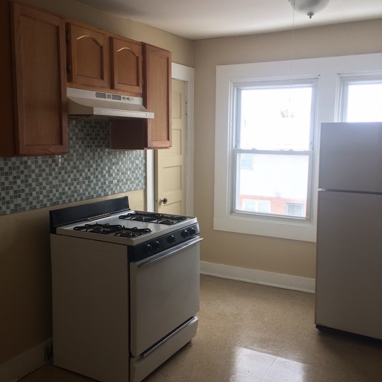 56 Windsor Street Springfield, MA 01105 - Photo 12 of 14 a stove top oven sitting inside of a kitchen