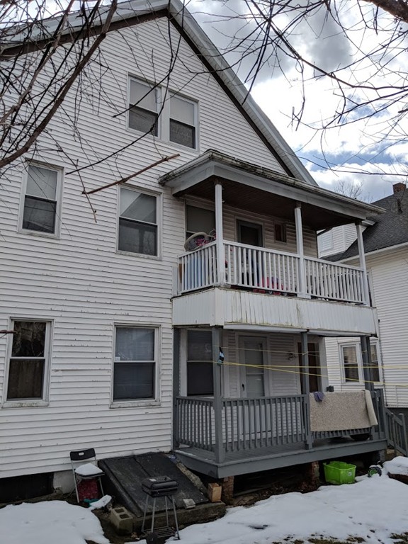 56 Windsor Street Springfield, MA 01105 - Photo 2 of 14 a front view of a house with a yard